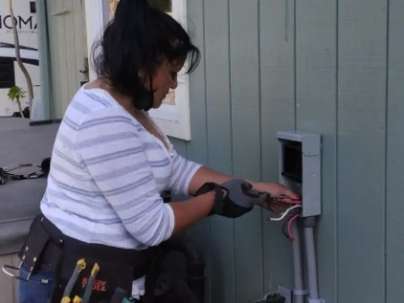 Licensed electrician wiring an exterior subpanel in Kewanee